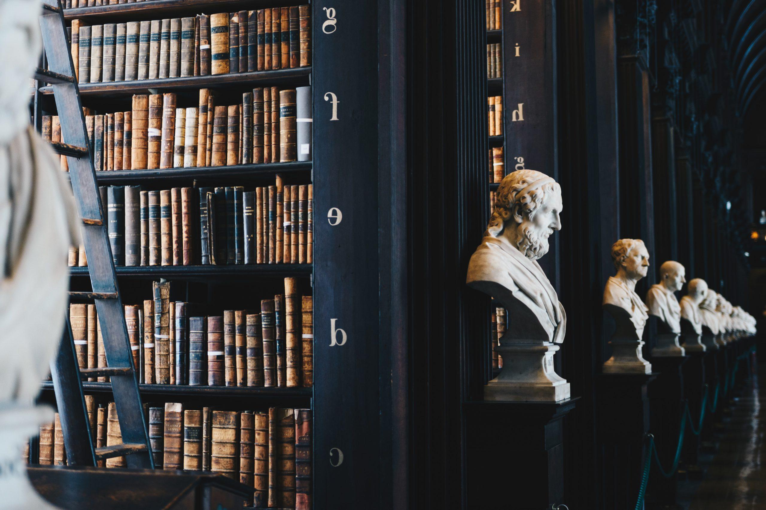 Picture of Busts in a library with books. Photo by Giammarco