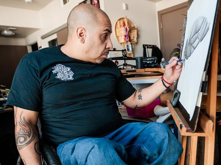 Alumnus Javier Flores works at his home studio.
